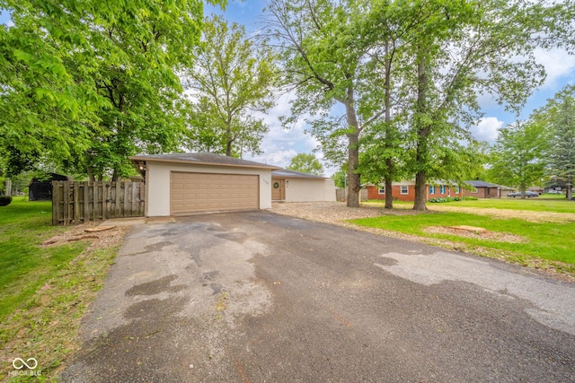 1127 Hickory Ln, New Castle, IN 47362 - view of front of property featuring asphalt driveway, stucco siding, and an attached garage