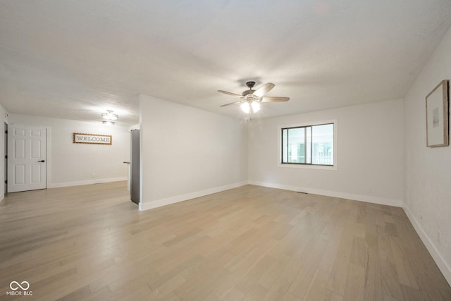 1127 Hickory Ln, New Castle, IN 47362 - spare room with ceiling fan, light wood-style floors, and baseboards