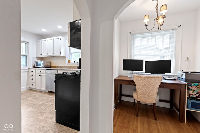 5259 Broadway St, Indianapolis, IN 46220 - home office with arched walkways, a chandelier, plenty of natural light, recessed lighting, and a sink
