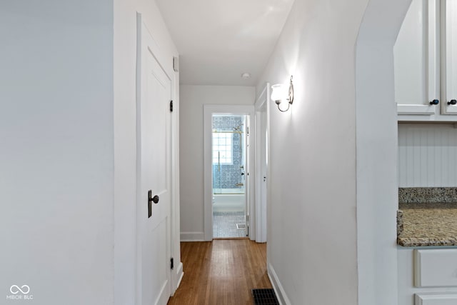 5259 Broadway St, Indianapolis, IN 46220 - hall with wood finished floors, baseboards, and arched walkways