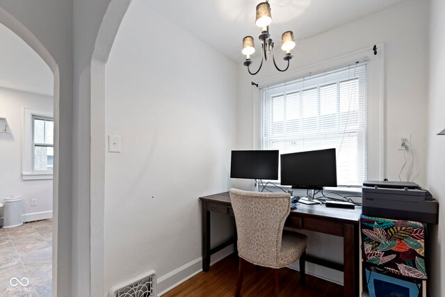 5259 Broadway St, Indianapolis, IN 46220 - office area with arched walkways, baseboards, and a chandelier