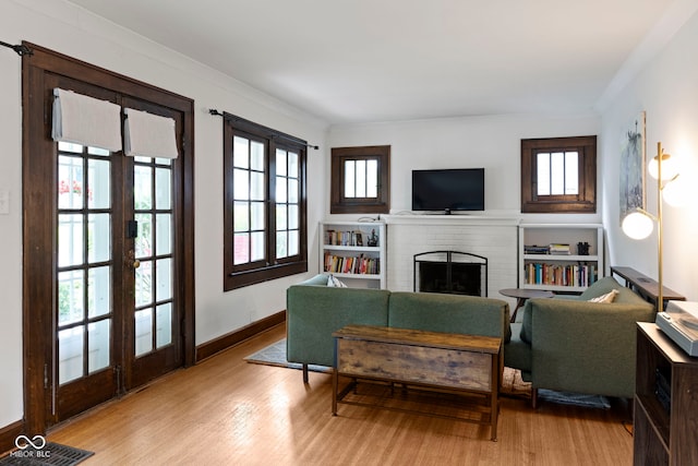 5259 Broadway St, Indianapolis, IN 46220 - living room with a brick fireplace, wood finished floors, french doors, baseboards, and ornamental molding