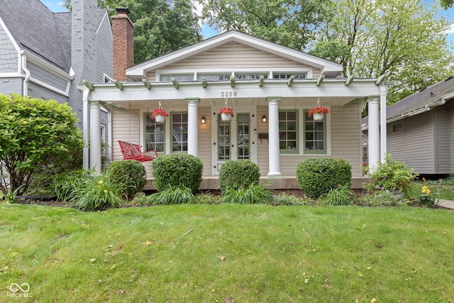 5259 Broadway St, Indianapolis, IN 46220 - neoclassical / greek revival house with a porch and a front yard