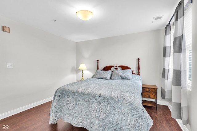 350 N Meridian St Unit 705, Indianapolis, IN 46204 - bedroom featuring baseboards and dark wood-type flooring
