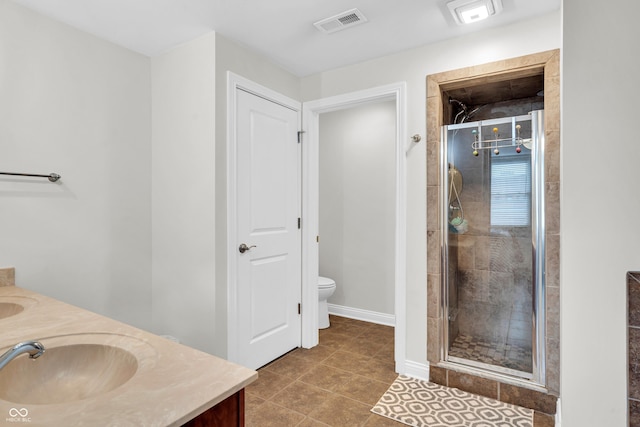 350 N Meridian St Unit 705, Indianapolis, IN 46204 - bathroom with double vanity, a shower stall, toilet, and baseboards