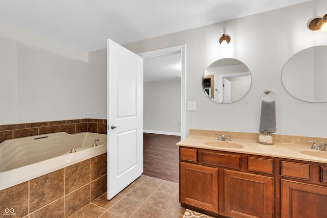 350 N Meridian St Unit 705, Indianapolis, IN 46204 - bathroom with double vanity, a bath, and tile patterned floors
