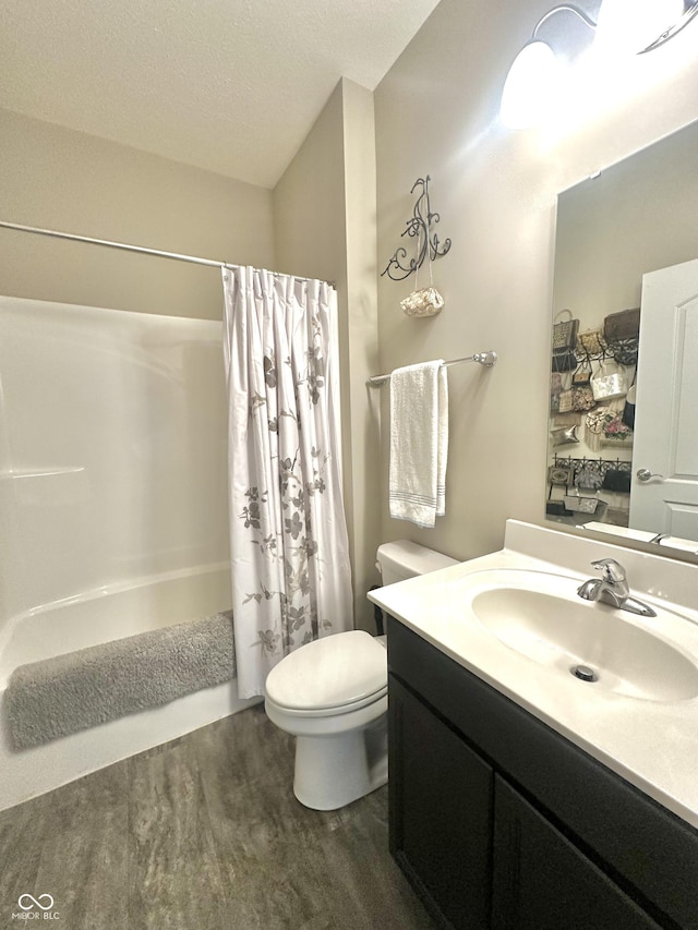 4209 Switchgrass Way, Indianapolis, IN 46237 - bathroom featuring toilet, vanity, wood finished floors, shower / tub combo with curtain, and a textured ceiling