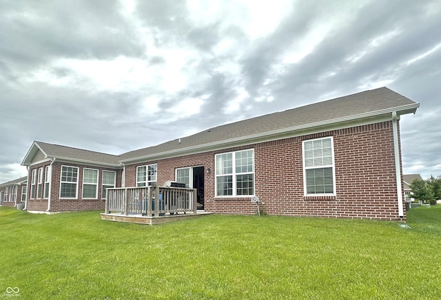 4209 Switchgrass Way, Indianapolis, IN 46237 - back of house featuring brick siding, a lawn, and a wooden deck