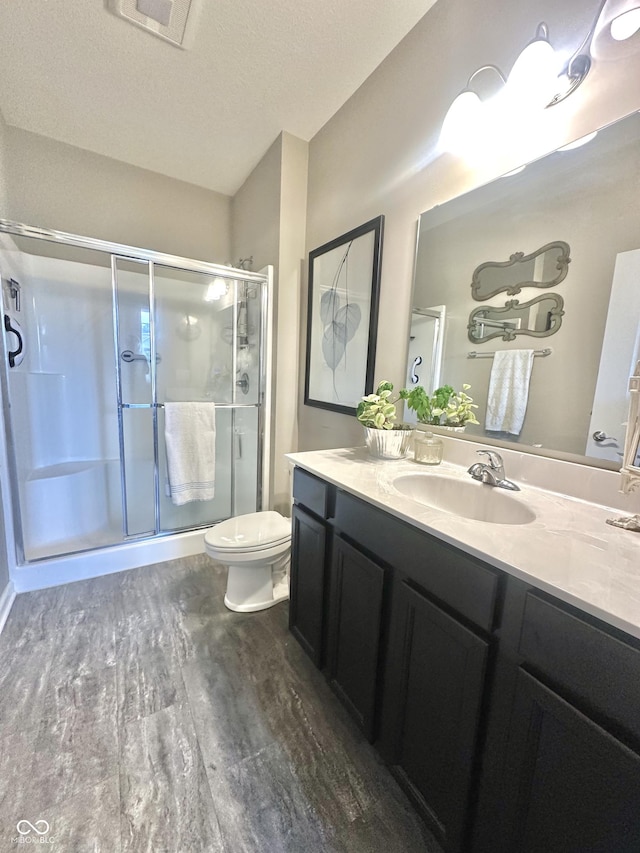 4209 Switchgrass Way, Indianapolis, IN 46237 - full bathroom with a shower stall, wood finished floors, vanity, and toilet