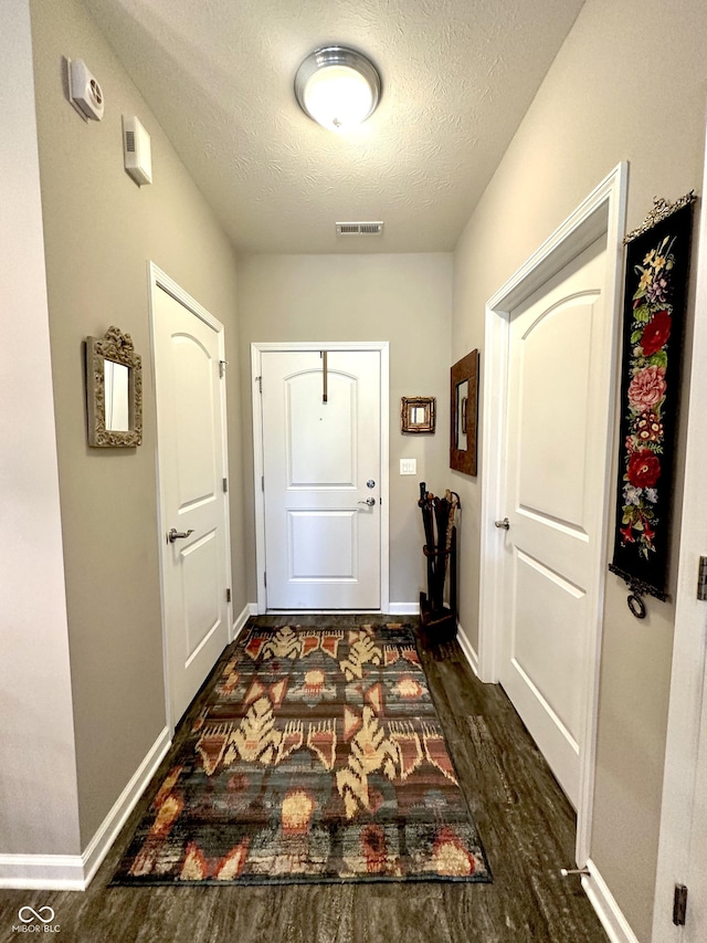 4209 Switchgrass Way, Indianapolis, IN 46237 - entryway featuring dark wood finished floors, a textured ceiling, and baseboards