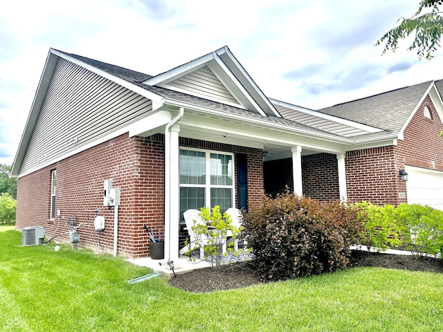 4209 Switchgrass Way, Indianapolis, IN 46237 - view of side of home with brick siding, a lawn, a garage, and roof with shingles