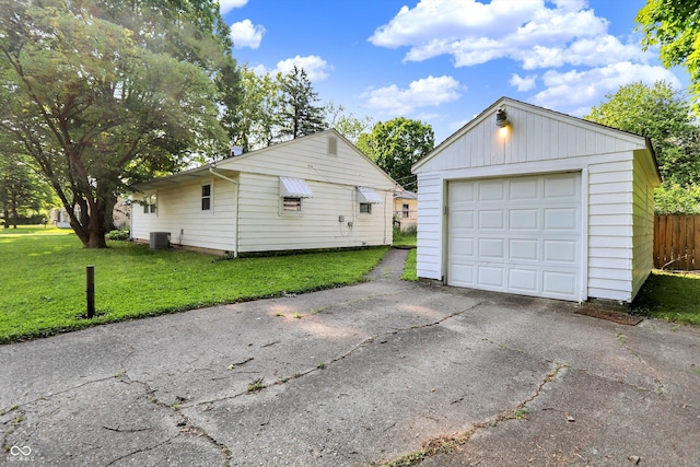 1868 N Hawthorne Ln, Indianapolis, IN 46218 - detached garage featuring central air condition unit and asphalt driveway