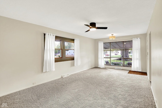 1868 N Hawthorne Ln, Indianapolis, IN 46218 - empty room featuring carpet floors, ceiling fan, and baseboards