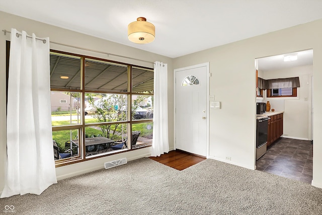 1868 N Hawthorne Ln, Indianapolis, IN 46218 - entrance foyer with dark carpet and baseboards
