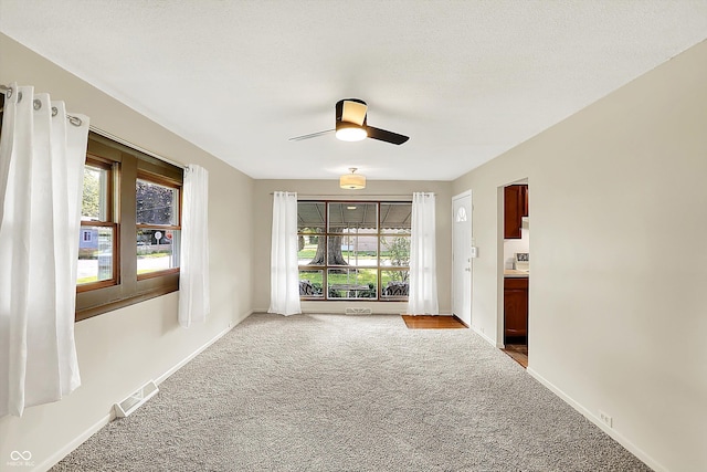 1868 N Hawthorne Ln, Indianapolis, IN 46218 - carpeted spare room featuring a ceiling fan, plenty of natural light, and baseboards