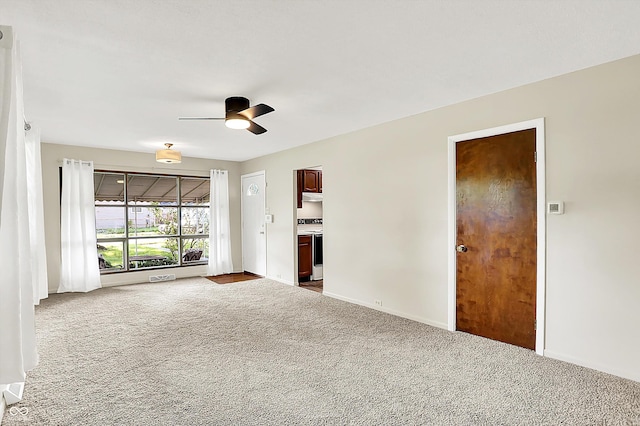 1868 N Hawthorne Ln, Indianapolis, IN 46218 - spare room with carpet, a ceiling fan, and baseboards