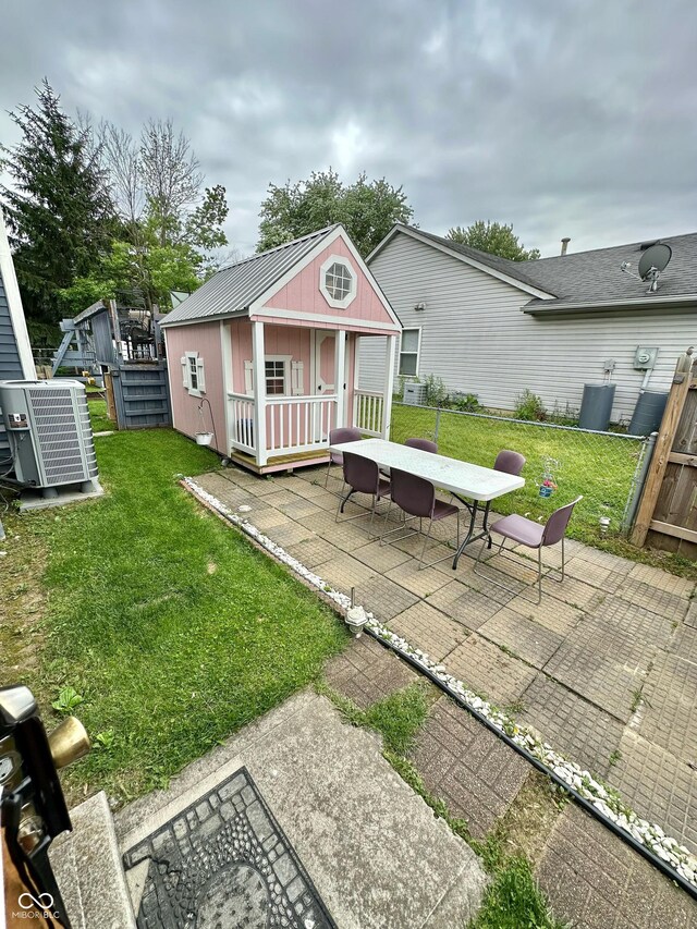 1831 Beckenbauer Ln, Indianapolis, IN 46214 - rear view of house with a patio area, an outbuilding, and outdoor dining area