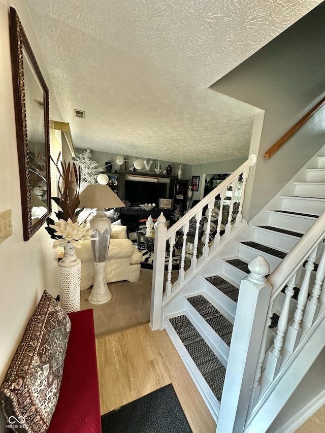 1831 Beckenbauer Ln, Indianapolis, IN 46214 - stairs with a textured ceiling and wood finished floors