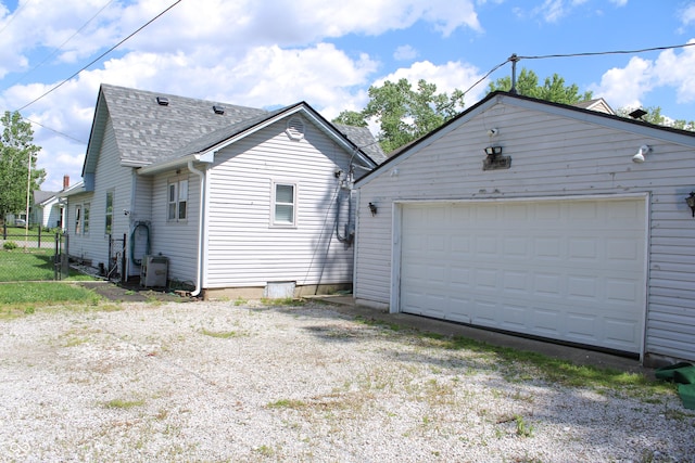 202 S Church St, Brooklyn, IN 46111 - view of side of home with roof with shingles, an outbuilding, ac unit, and a detached garage