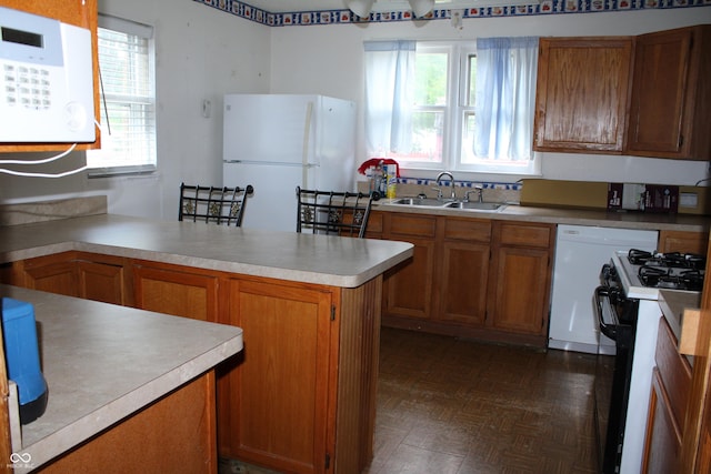 202 S Church St, Brooklyn, IN 46111 - kitchen with white appliances, a sink, brown cabinets, and a peninsula