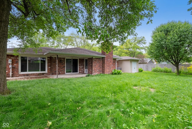4904 N Tillotson Ave, Muncie, IN 47304 - rear view of property with a patio, a chimney, and brick siding