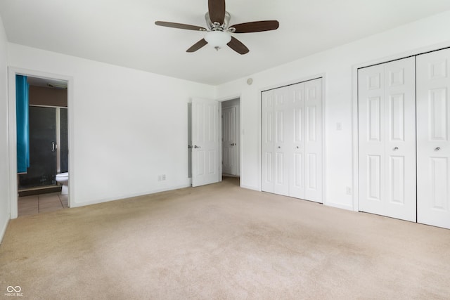 4904 N Tillotson Ave, Muncie, IN 47304 - unfurnished bedroom with carpet flooring, two closets, ensuite bath, baseboards, and ceiling fan