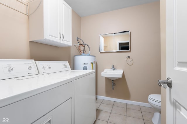 4904 N Tillotson Ave, Muncie, IN 47304 - laundry room featuring water heater, washer and dryer, light tile patterned floors, and baseboards