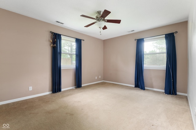 4904 N Tillotson Ave, Muncie, IN 47304 - empty room featuring a ceiling fan, plenty of natural light, light carpet, and baseboards