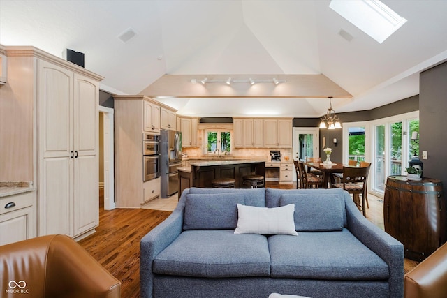 8301 Reef Ct, Indianapolis, IN 46236 - living area with lofted ceiling, light wood-style floors, and a skylight