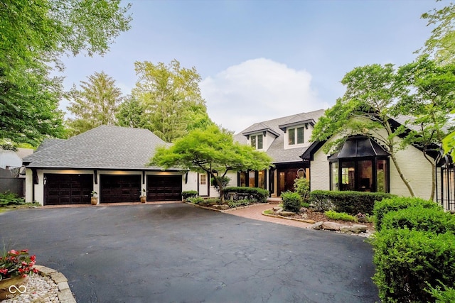 8301 Reef Ct, Indianapolis, IN 46236 - view of front of house featuring a garage, asphalt driveway, and brick siding