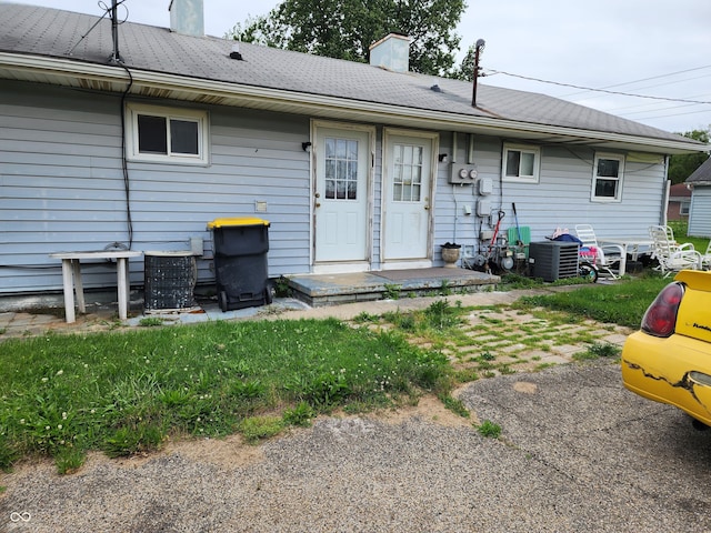 615 E 31st St, Anderson, IN 46016 - rear view of house with a chimney and central AC