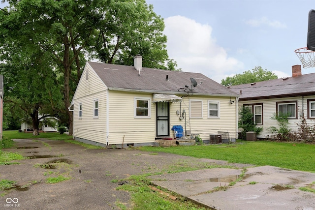 3338 Orchard Ave, Indianapolis, IN 46218 - rear view of property with a lawn, a chimney, and a shingled roof