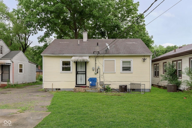 3338 Orchard Ave, Indianapolis, IN 46218 - rear view of property with a yard, a chimney, cooling unit, and crawl space
