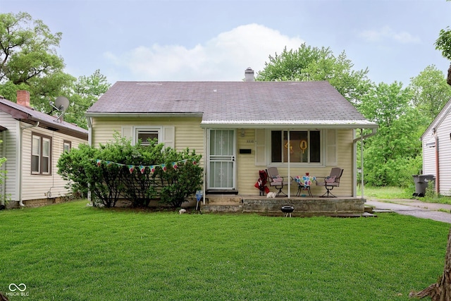 3338 Orchard Ave, Indianapolis, IN 46218 - view of front of property featuring a porch, a front yard, and a chimney