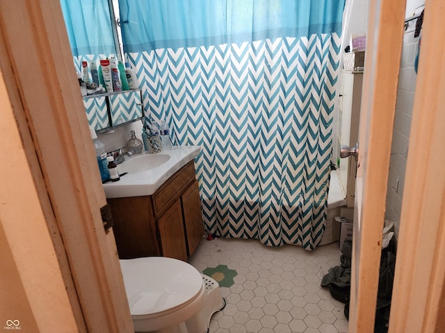 621 E 31st St, Anderson, IN 46016 - bathroom featuring toilet, vanity, and tile patterned flooring