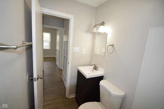 1902 N Colorado Ave, Indianapolis, IN 46218 - bathroom with toilet, vanity, wood finished floors, and baseboards