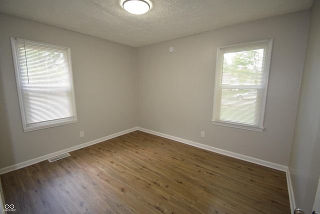 1902 N Colorado Ave, Indianapolis, IN 46218 - spare room with plenty of natural light, wood finished floors, a textured ceiling, and baseboards