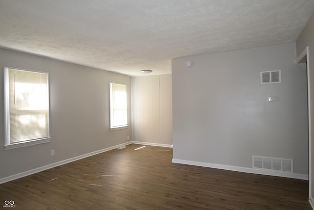 1902 N Colorado Ave, Indianapolis, IN 46218 - empty room with a textured ceiling, dark wood finished floors, and baseboards