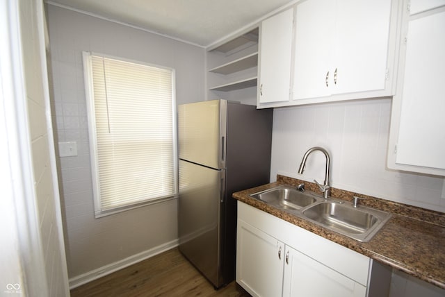 1902 N Colorado Ave, Indianapolis, IN 46218 - kitchen with a sink, freestanding refrigerator, white cabinetry, dark countertops, and dark wood finished floors