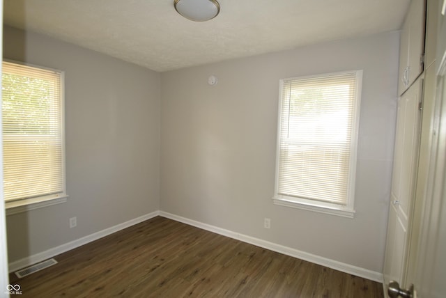 1902 N Colorado Ave, Indianapolis, IN 46218 - unfurnished room with baseboards, dark wood finished floors, and healthy amount of natural light