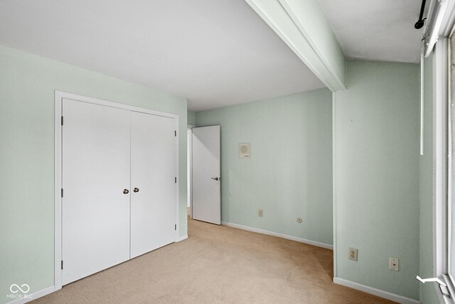 3975 Offshore Dr, Columbus, IN 47203 - unfurnished bedroom featuring light carpet, baseboards, and a closet
