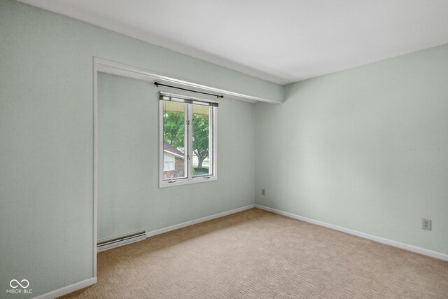 3975 Offshore Dr, Columbus, IN 47203 - carpeted empty room with a baseboard heating unit and baseboards