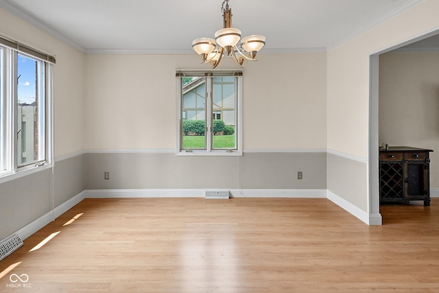 3975 Offshore Dr, Columbus, IN 47203 - unfurnished room featuring light wood finished floors, a chandelier, ornamental molding, and baseboards