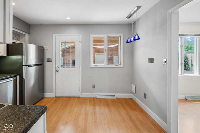 3975 Offshore Dr, Columbus, IN 47203 - kitchen featuring appliances with stainless steel finishes, light wood-style floors, baseboards, hanging light fixtures, and white cabinets