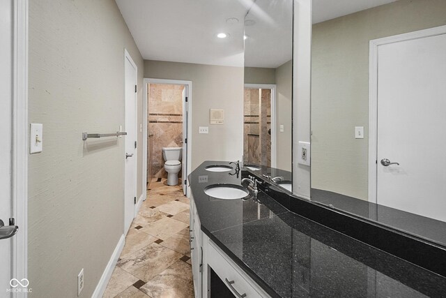 3975 Offshore Dr, Columbus, IN 47203 - bathroom featuring toilet, double vanity, and baseboards