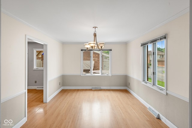 3975 Offshore Dr, Columbus, IN 47203 - unfurnished room with a chandelier, plenty of natural light, light wood-style flooring, baseboards, and crown molding