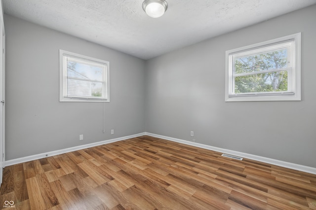 420 Vista Dr, Carmel, IN 46280 - unfurnished room featuring healthy amount of natural light, wood finished floors, and baseboards