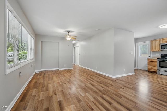 420 Vista Dr, Carmel, IN 46280 - unfurnished living room with light wood finished floors, baseboards, and ceiling fan