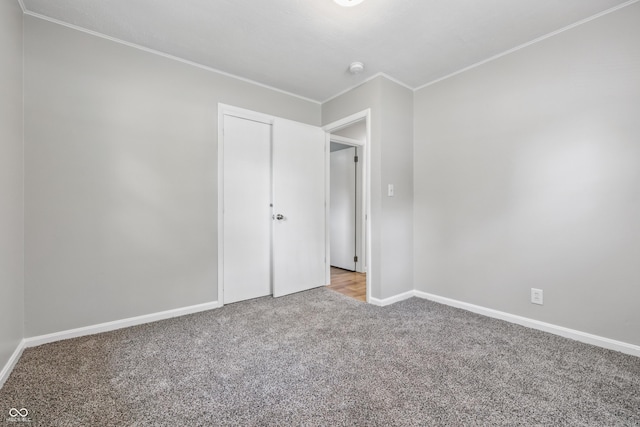 420 Vista Dr, Carmel, IN 46280 - unfurnished bedroom with carpet, crown molding, baseboards, and a closet