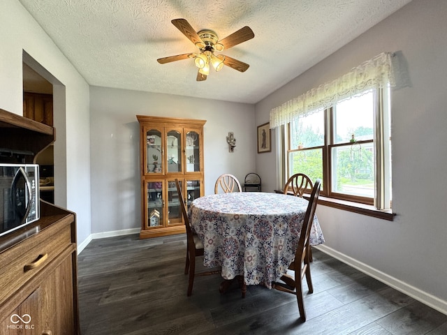 7445 Melanie Ln, Indianapolis, IN 46217 - dining room with ceiling fan, dark wood-style floors, baseboards, and a textured ceiling